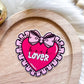 A heart shaped Book Lover Sticker with the words book lover on it.